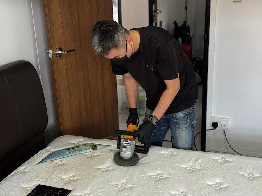 A man with a cleaning machine for mattress